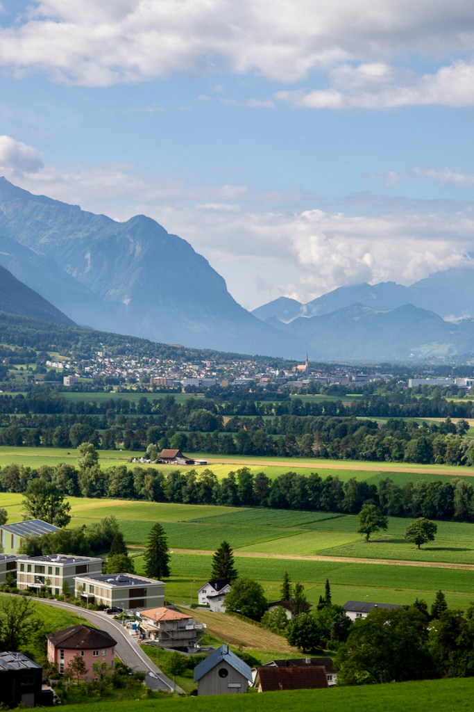 Green valley with villages below the mountains of Liechtenstein
